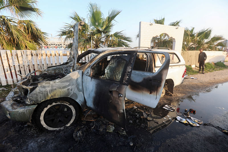 A person looks at a vehicle where employees from the World Central Kitchen (WCK), including foreigners, were killed in an Israeli airstrike, according to the NGO as the Israeli military said it was conducting a thorough review at the highest levels to understand the circumstances of this “tragic” incident, amid the ongoing conflict between Israel and Hamas, in Deir Al-Balah, in the central Gaza, Strip on 2 April, 2024