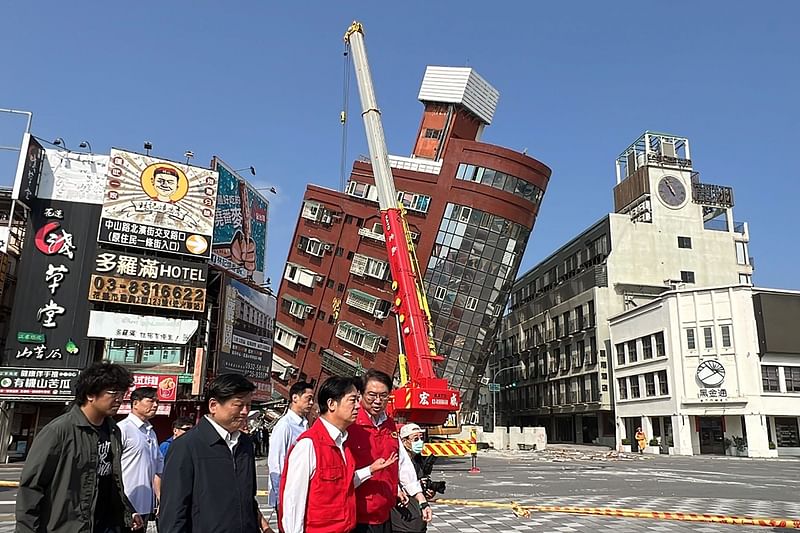 This photo taken by Taiwan's Central News Agency (CNA) on 3 April, 2024 shows Taiwan's president-elect and current Vice-President Lai Ching-te (3rd R) surveying damage in Hualien, after a major earthquake hit Taiwan's east