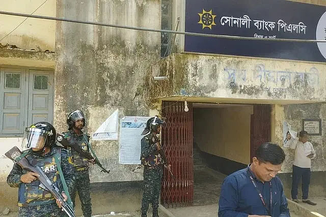 Members of law enforcement agencies guarding the Ruma branch of Sonali Bank