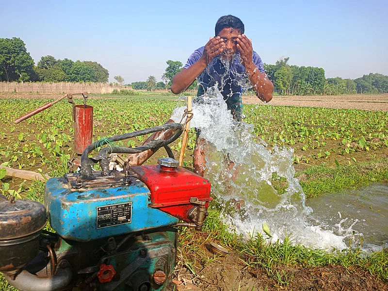 A farmer washes his face in the cool water of a shallow machine in Chuadanga