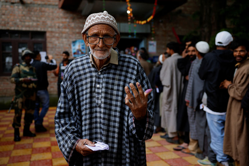 A man shows his ink-stained finger after voting at a polling station, during the fourth general election phase, in south Kashmir's Pulwama district, May 13, 2024.