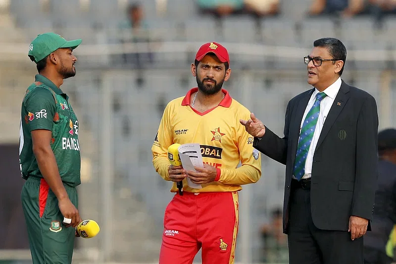 Bangladesh skipper Najmul Hossain Shanto (L) and Zimbabwe captain Sikandar Raza during the toss in the 4th T20 international