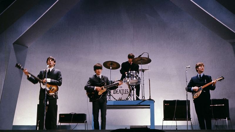 English band The Beatles (from left to right), Paul McCartney (bass), George Harrison (guitar), Ringo Starr (drums) et John Lennon (guitar) perform on stage during a concert, 29 July 1965, in London. "Let it Be", the documentary film about The Beatles released just after the band's break up in 1970, hit screens again on 8 May, 2024 -- the first time it has been legally available in over 50 years. Shot in January 1969, director Michael Lindsay-Hogg's movie contained glimpses of the tensions and acrimony between John Lennon, Paul McCartney, George Harrison and Ringo Starr that eventually led to them disbanding.