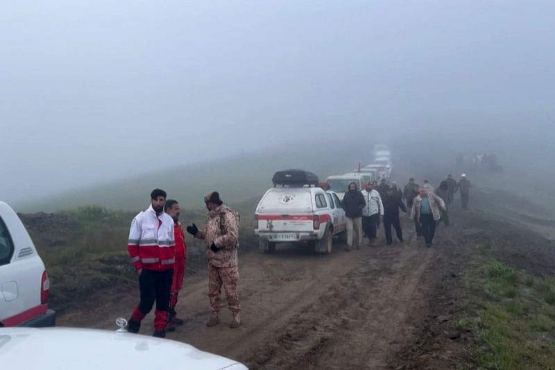 This grab taken from handout video footage released by the Iranian Red Cescent on 20 May, 2024 shows search and rescue teams as they try to locate President Ebrahim Raisi's helicopter which went missing in a mountainous area of northwest Iran. Raisi was declared dead on 20 May, 2024, after rescue teams found his crashed helicopter in a fog-shrouded western mountain region, sparking mourning in the Islamic republic.