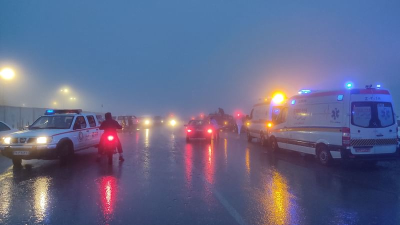 In this photo provided by MojNews on May 19, 2024, rescuers gather before heading towards the site of the "accident" involving a helicopter in the convoy of Iran's President in the Jolfa region of the western province of East Azerbaijan