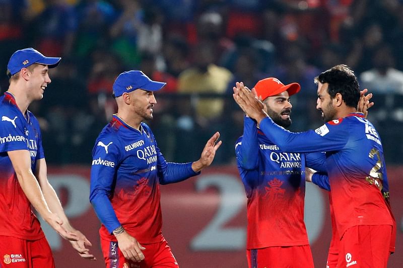 Royal Challengers Bengaluru's celebrate after the dismissal of Punjab Kings' Liam Livingstone during the Indian Premier League (IPL) Twenty20 cricket match between Punjab Kings and Royal Challengers Bengaluru at the Himachal Pradesh Cricket Association Stadium in Dharamsala on 9 May, 2024