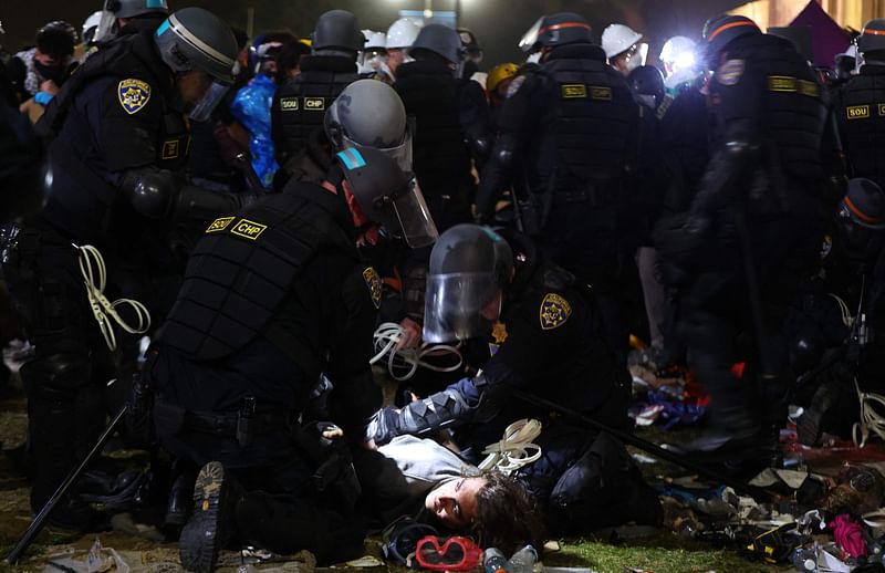 California Highway Patrol (CHP) officers detain a protestor while clearing a pro-Palestinian encampment after dispersal orders were given at the University of California, Los Angeles (UCLA) campus, on 2 May, 2024 in Los Angeles, California