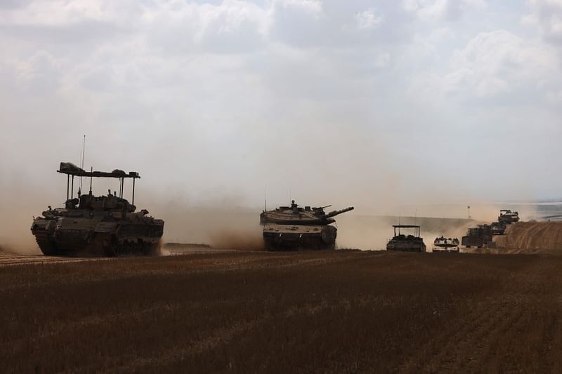 Israeli military vehicles roll near the border with the Gaza Strip on 12 May, 2024, amid the ongoing conflict between Israel and the Palestinian Hamas movement