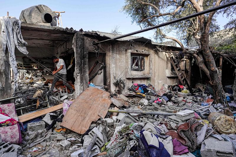 A Palestinian man walks on the rubble of a destroyed house in Nuseirat following Israeli bombardment overnight on 23 May, 2024, amid continuing battles between Israel and Hamas in the Gaza Strip