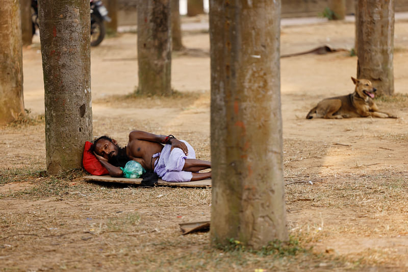 A man sleeps under a tree during a countrywide heatwave in Dhaka, Bangladesh, on 28 April, 2024