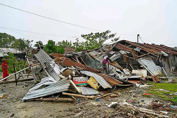 Houses have been damaged in Cyclone Remal. A man is looking for intact belongings. The picture was taken from Kuakata in Patuakhali