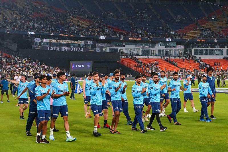 Gujarat Titans' players greet their fans after the Indian Premier League (IPL) Twenty20 cricket match between Gujarat Titans and Kolkata Knight Riders was abandoned due to rain at the Narendra Modi Stadium in Ahmedabad on May 13, 2024