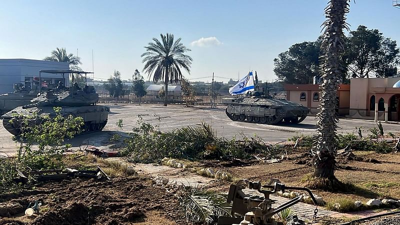 This handout picture released by the Israeli army shows the 401st Brigade's combat team tanks entering the Palestinian side of the Rafah border crossing between Gaza and Egypt in the southern Gaza Strip on 7 May, 2024. The Israeli army said it took "operational control" of the Palestinian side of the Rafah border crossing on 7 May and that troops were scanning the area.