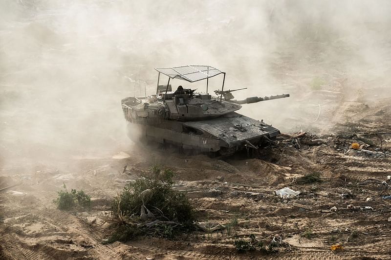 This handout picture released by the Israeli army on 30 May, 2024 shows an Israeli army tank during military operations around Jabalia in the northern Gaza Strip, amid the ongoing conflict between Israel and the Palestinian militant group Hamas. Rafah residents reported intense artillery shelling and gunfire on 30 May in Gaza's far-southern city after Israel said it had seized a strategic corridor on the Palestinian territory's border with Egypt.