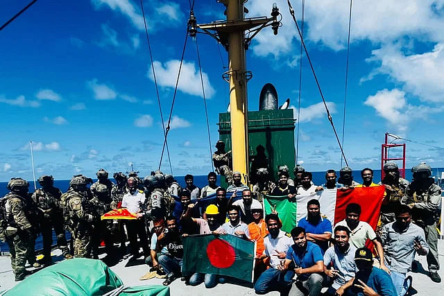 Elated sailors on the deck of MV Abdullah with the national flag