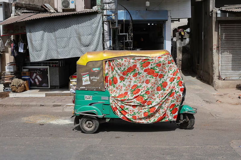 An autorickshaw covered with a cloth is seen on the street during a heat wave in Ahmedabad, India, on 30 May, 2024.