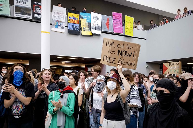 People demonstrate in the ABC building of the University of Amsterdam on the Roeterseiland campus in central Amsterdam on 13 May, 2024 in the wake of similar protests of students at universities in several European countries that have followed the actions on US campuses where demonstrators have occupied halls and facilities to demand an end to partnerships with Israeli institutions because of Israel’s punishing assault on Gaza