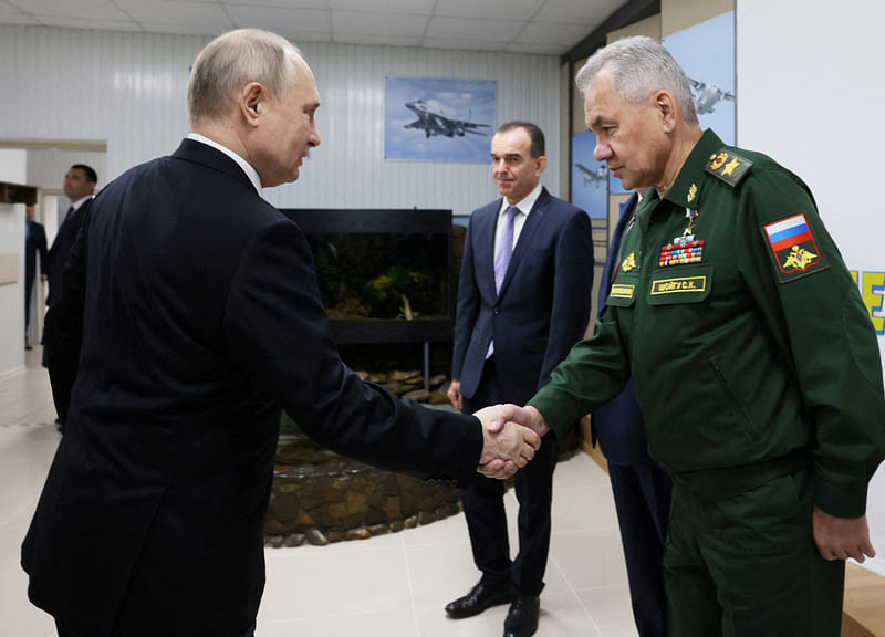 Russian president Vladimir Putin shakes hands with former defence minister Sergei Shoigu as they visit the Higher Military Aviation School of Pilots named after Hero of the Soviet Union AK Serov in Krasnodar, Russia 7 March, 2024.