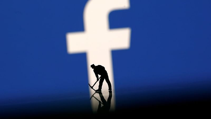 A figurine is seen in front of the Facebook logo in this illustration. Reuters file photo