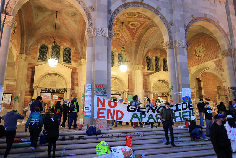 Protesters supporting Palestinians in Gaza walk at an encampment at the University of California Los Angeles (UCLA), as the conflict between Israel and the Palestinian Islamist group Hamas continues, in Los Angeles, California, US, on 1 May, 2024