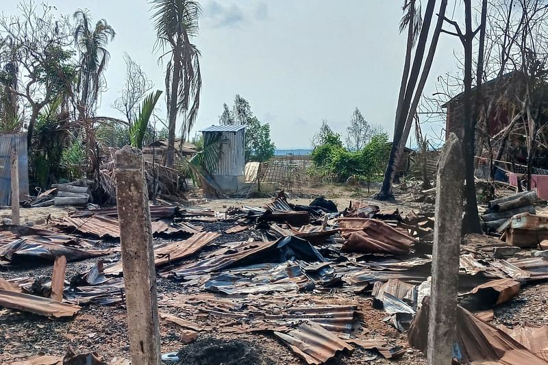 This photo taken on 21 May, 2024 shows a destroyed house and burned trees following fighting between Myanmar’s military and the Arakan Army (AA) ethnic minority armed group in a village in Minbya Township in western Rakhine State