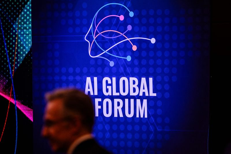 A guest walks past signage for the AI Global Forum, displayed inside an auditorium before its opening ceremony, on the sidelines of the AI Seoul Summit, in Seoul on 22 May 2024.