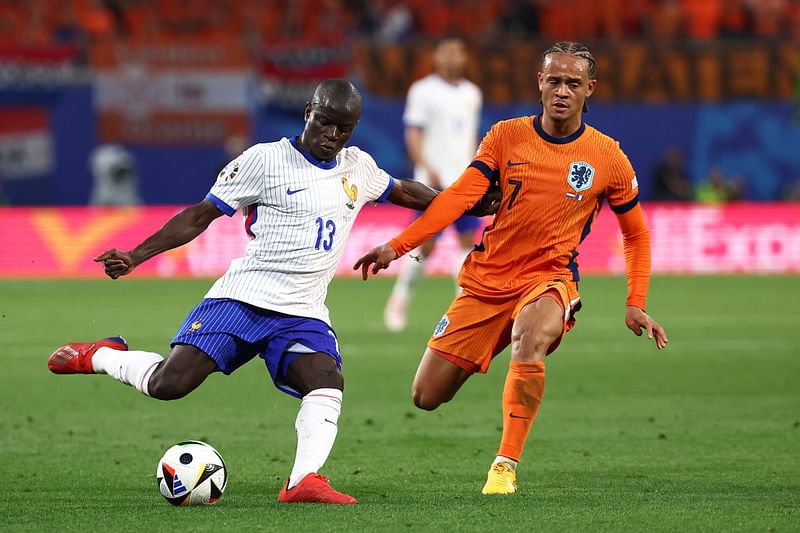 France's midfielder #13 N'golo Kante (L) fights for the ball with Netherlands' forward #07 Xavi Simons during the UEFA Euro 2024 Group D football match between the Netherlands and France at the Leipzig Stadium in Leipzig on 21 June, 2024.