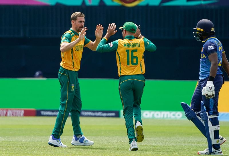 South Africa's Anrich Nortje celebrates with South Africa's Keshav Maharaj (C) after Sri Lanka's Kamindu Mendis (R) is dismissed during the ICC men's Twenty20 World Cup 2024 group D cricket match between Sri Lanka and South Africa at Nassau County International Cricket Stadium in East Meadow, New York on June 3, 2024