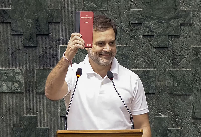Congress MP Rahul Gandhi shows a copy of the Constitution of India while taking oath as a Member of the 18th Lok Sabha during its second day, at the Parliament, in New Delhi on 25 June, 2024