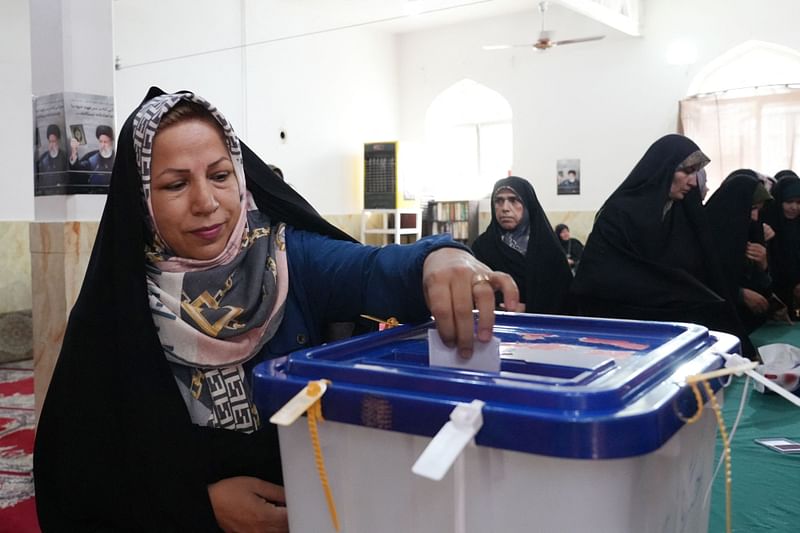 An Iranian woman casts her ballot at a polling station during presidential election in Tehran on 28 June, 2024. Around 61 million Iranians are eligible to vote in the election on 28 June, called after the death of ultraconservative president Ebrahim Raisi in a helicopter crash last month.