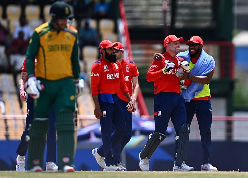 England celebrates after dismissing South Africa's Quinton de Kock during the ICC men's Twenty20 World Cup 2024 Super Eight cricket match between England and South Africa at Daren Sammy National Cricket Stadium in Gros Islet, Saint Lucia, on 21 June 2024.
