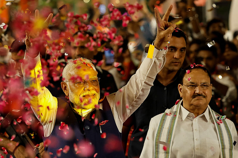 Supporters throw petals on Indian Prime Minister Narendra Modi as he arrives at Bharatiya Janata Party (BJP) headquarters in New Delhi, India, 4 June 2024.