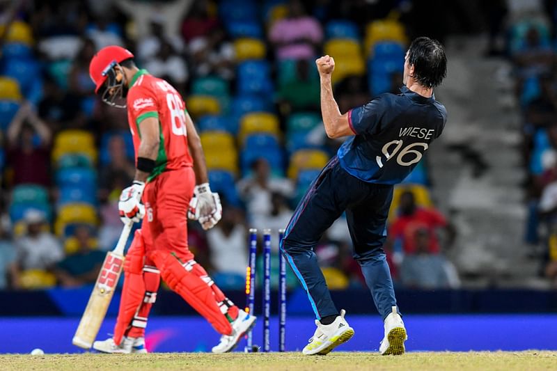 Oman's Naseem Khushi (L) is bowled by Namibia's David Wiese in the super over during the ICC men's Twenty20 World Cup 2024 group B cricket match between Namibia and Oman at Kensington Oval, in Bridgetown, Barbados on 2 June 2024.