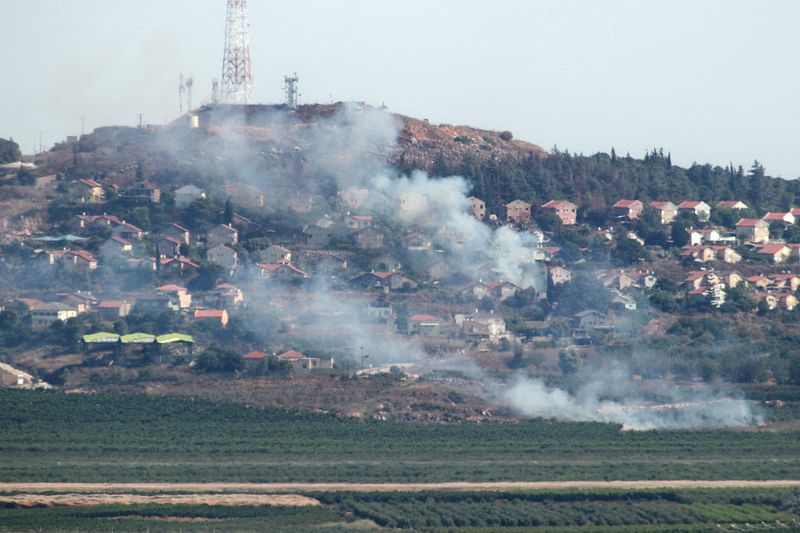 A photo taken from southern Lebanon shows smoke billowing in the Israeli northern town of Metulla from cross-border rockets launched from the Lebanese side on 26 June, 2024.