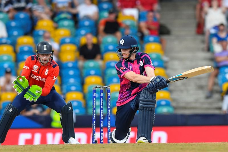 Michael Jones (R) of Scotland hits 4 as Jos Buttler (L) of England watches during the ICC MenÕs T20 CWC group B match between England and Scotland at Kensington Oval in Bridgetown, Barbados, on 4 June 2024.