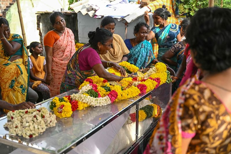 Family members weep next to the dead body of a victim who died after consuming toxic alcohol in Kallakurichi district of India's Tamil Nadu state on 20 June, 2024.