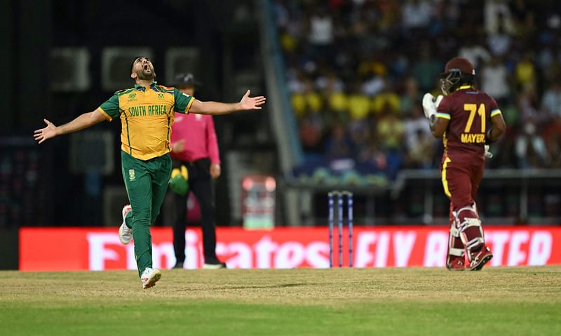 South Africa's Tabraiz Shamsi reacts after the dismissal of West Indies' Kyle Mayers (R) during the ICC men's Twenty20 World Cup 2024 Super Eight cricket match between West Indies and South Africa at Sir Vivian Richards Stadium in North Sound, Antigua and Barbuda on 23 June 2024.