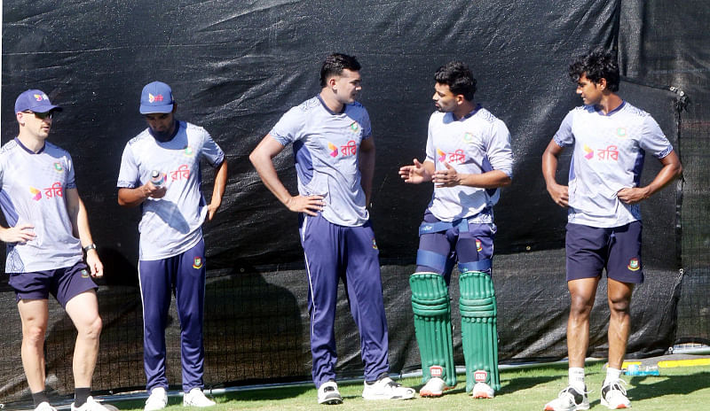 Bangladesh national cricket team skipper Najmul Hossain speaks to fellow team mates during a practice session