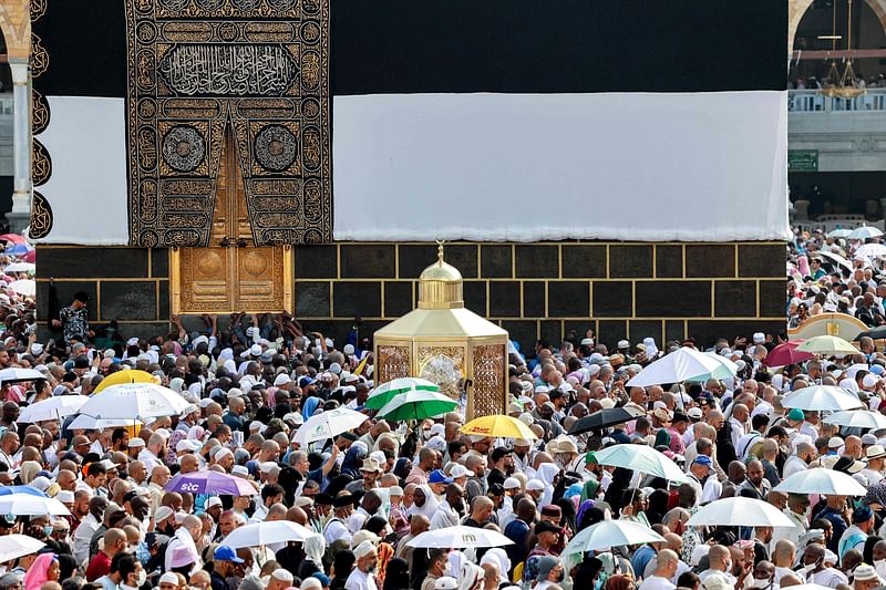 Muslim pilgrims move past Maqam Ibrahim (the Station of Abraham) as they perform the farewell circumambulation or "tawaf", circling seven times around the Kaaba, Islam's holiest shrine, at the Grand Mosque in the holy city of Mecca on 18 June 2024 at the end of the annual hajj pilgrimage.