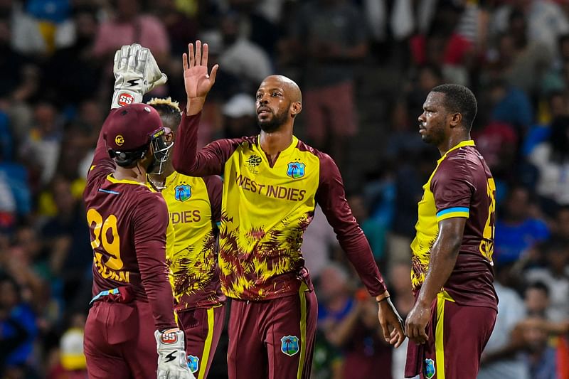 West Indies' Roston Chase (C) and Johnson Charles (R) celebrate the dismissal of USA's Corey Anderson during the ICC men's Twenty20 World Cup 2024 Super Eight cricket match between USA and West Indies at Kensington Oval in Bridgetown, Barbados on 21 June, 2024