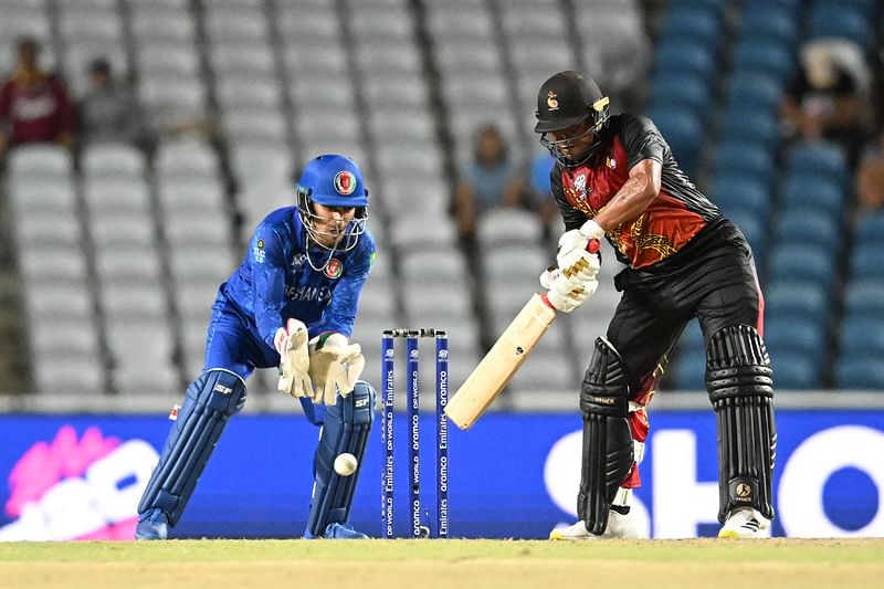 Papua New Guinea's Kipling Doriga hits four during the ICC men's Twenty20 World Cup 2024 group C cricket match between Afghanistan and Papua New Guinea at Brian Lara Cricket Academy Stadium in Tarouba, Trinidad and Tobago on 13 June, 2024