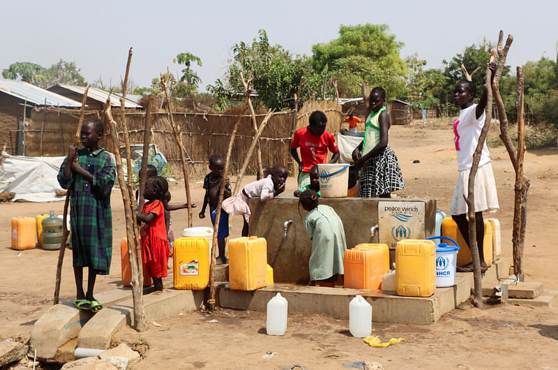 Sudanese refugees collect water from a borehole at the Gorom Refugee camp hosting Sudanese refugees who fled recent fighting, near Juba, in South Sudan on 26 January, 2024