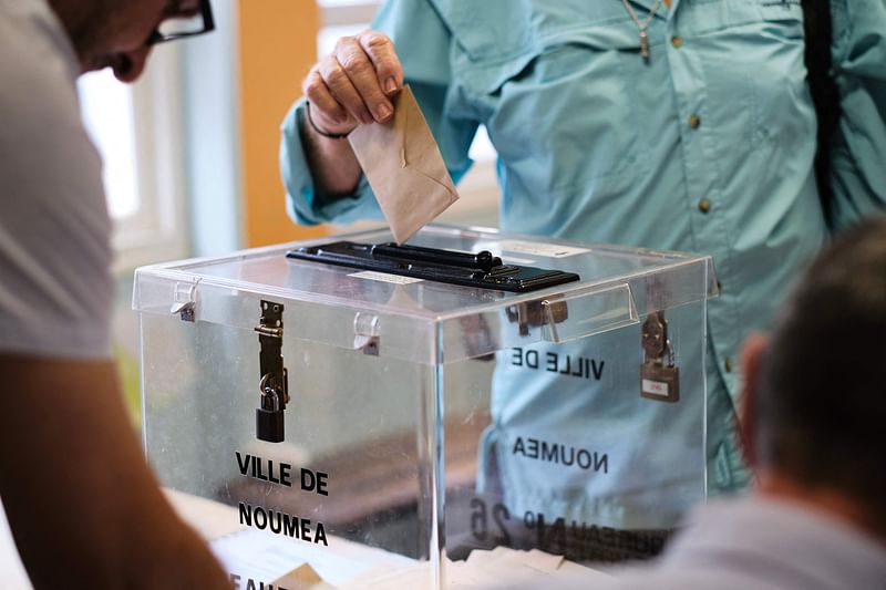 A person casts their vote at a polling station in the Magenta district during the first round of France's crunch legislative elections in Noumea in the first constituency of the French Pacific territory of New Caledonia, on 30 June, 2024