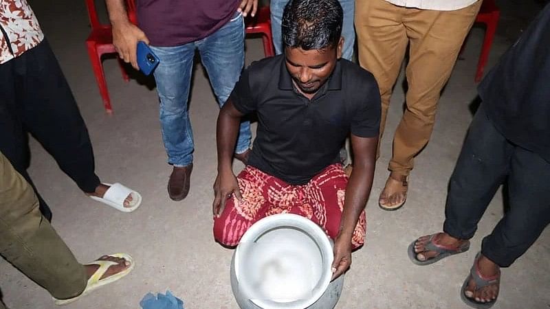 Rezaul Khan with the Russel's viper snake he caught from his land in Faridpur on 22 June, 2024