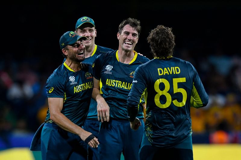 Australia's Pat Cummins (3L) and Marcus Stoinis (L) celebrates after the dismissal of Afghanistan's Gulbadin Naib during the ICC men's Twenty20 World Cup 2024 Super Eight cricket match between Afghanistan and Australia at Arnos Vale Stadium in Arnos Vale, Saint Vincent and the Grenadines on 22 June 2024