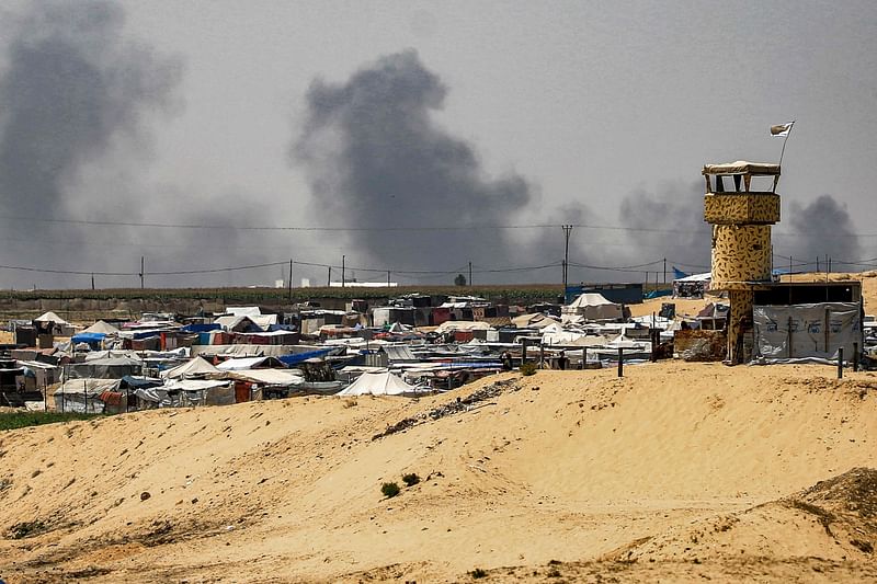 Smoke plumes billow near tents sheltering displaced Palestinians in Rafah in the southern Gaza Strip on 4 June, 2024