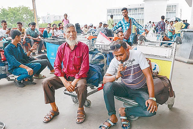 Workers waiting at the airport to go to Malaysia on Friday