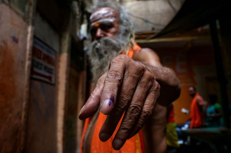 A Hindu priest shows his indelible ink mark after casting his vote at a polling station during the seventh and final phase of voting in India's general election, in Varanasi on 1 June, 2024. India's six-week election reached its final day of voting on 1 June, including in the holy city Prime Minister Narendra Modi has used as a staging post for his Hindu nationalist agenda.