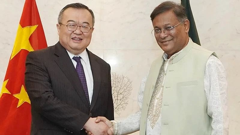 Bangladesh foreign minister Hasan Mahmud (R) and Liu Jianchao, Minister of the International Department of the Communist Party of China, shake hands after a meeting on 24 June, 2024