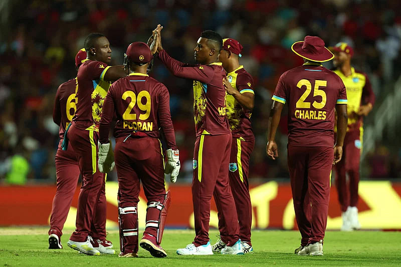 West Indies players celebrate a wicket of New Zealand